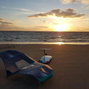blue and white boat on beach during sunset