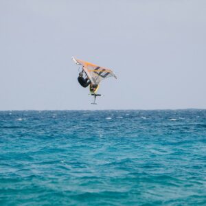 a person on a surfboard in the air over the ocean