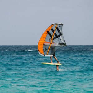 A person windsurfing in the ocean on a sunny day